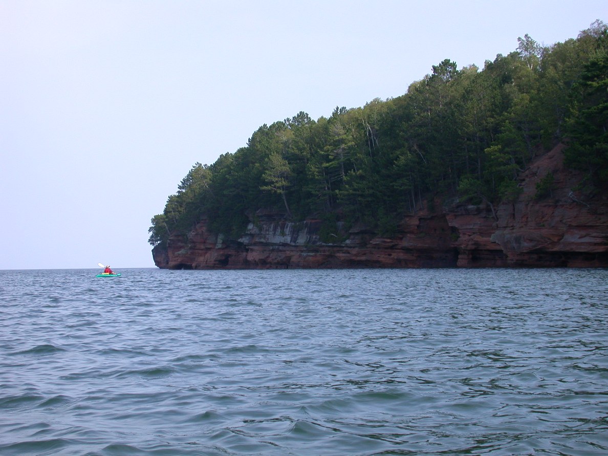 The Destination
There are about 25 miles of these sandstone bluffs containing hundreds of sea caves big and small. The tiny dot on the left is my kayaking cousin, Barbara, who seems right at home in Lake Superior.
