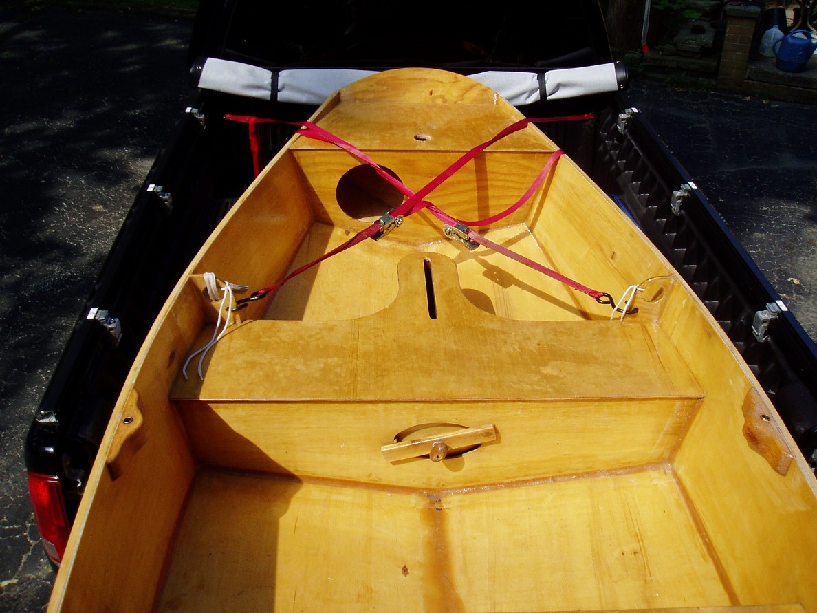 Tie Downs
This is how the boat is lashed in the bed. There is a third strap that goes across the middle of the hull. 
The backward hatch covers (with the lid on the inside) are used because it eliminates a prossible leak around the threaded stud. Inside covers require an oval opening. 
