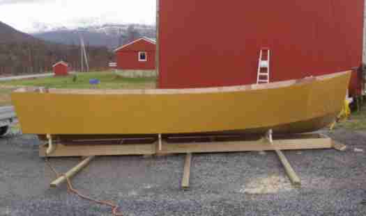 The primed hull
This picture shows the glassed, partly faired and pimed hull as it was stored away for the winter. For 6 months to come there will be no work done. Living in nothern Norway you cannot do epoxy work in fall, winter and even spring unless you are working inside. Unfortnunately I don't. 

