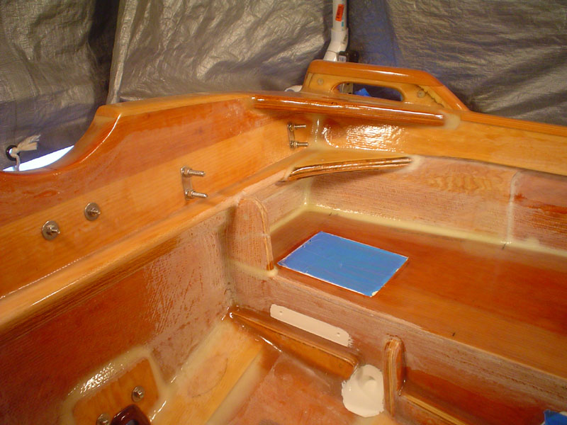 Transom mods for ladder and other
The transom was strengthened with these clamping boards, oak trim and secondary knees, both to accomodate the heavy 4 stroke, and boarding ladder *loads*, and other mods that mount to these, like the removeable stern seat with rod holders and icebox.  I tried to make every mod have at least two possible functions or options.
