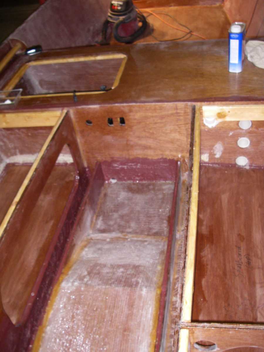 GF-16 tunnel stringers glassed
This is a view looking at the forward area of the tunnel and it's stringers.  These were glassed to the hull and mid-seat rear frame.  The glass has already been faired, although roughly, on the vertical surfaces.  I am not fairing the tunnel top or hull bottom to eliminate the need to add a non-skid to the paint.
Keywords: GF-16 tunnel stringers