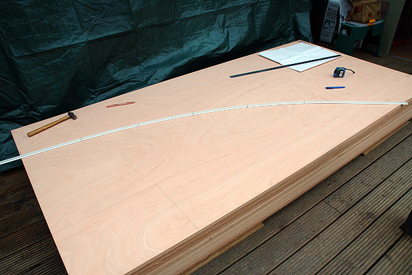 C17: Marking out berth panels.
Using nails and a flexible plastic strip to achieve a smooth curve.
