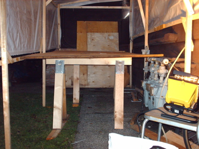 So much for a flat surface...
Thought I could use this random sheet of 3/4" plywood as a nice flat surface on which to splice my panels.  Doesn't look all that flat from this angle.  Oh, well.  Hopefully it won't be too much of a problem...

I also thought I had specifically built this tent 5' wide so I'd have a (narrow) space alongside a 4' sheet to work.  Not sure where that foot went.  Luckily, it's not raining, so I can unhook the side and stick my head in that way.
