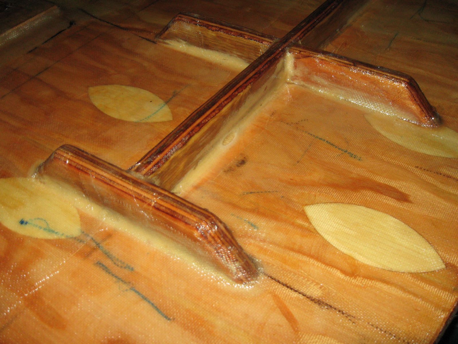 Stiffeners
marine fir with 9oz cloth over the stiffeners and 6oz in the flat areas to stop checking.
