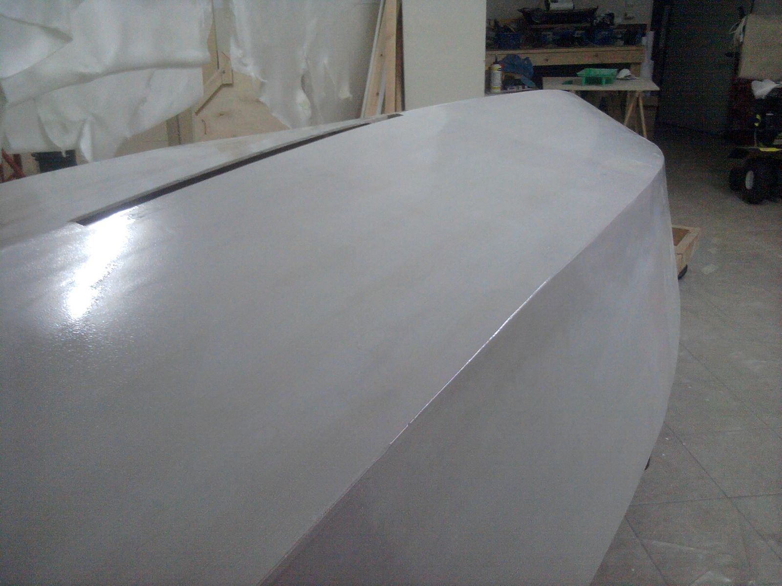 It may have been a real challenge to lay out the fiberglass on top of this but it looks really nice. I will be applying white pigmented epoxy over the flaring filler once I an done before I primer the hull. 
