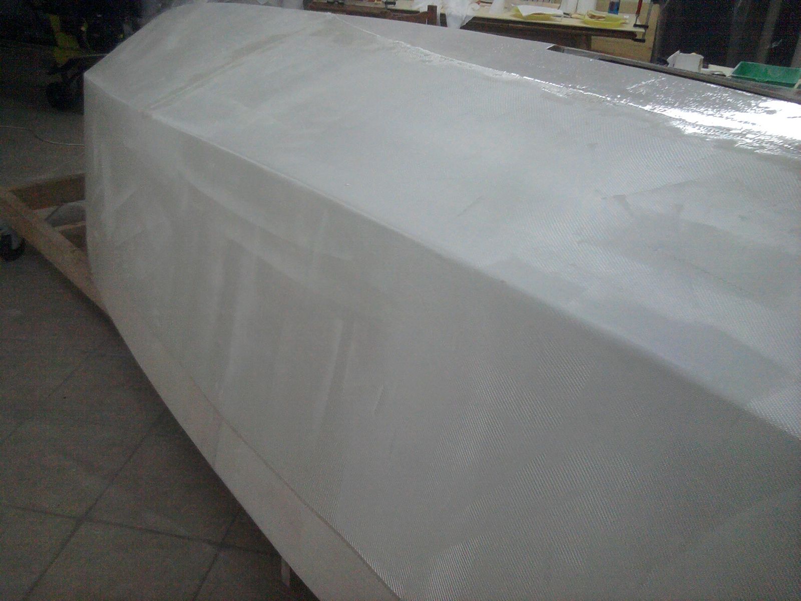Laying out the fiberglass sheet. You can’t really see it because of the white pigmented epoxy coat
